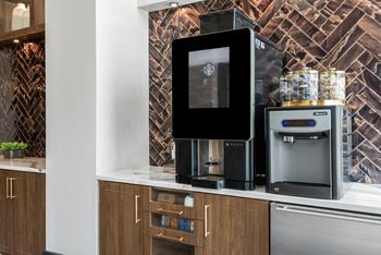 a kitchen with a coffee machine and a refrigerator